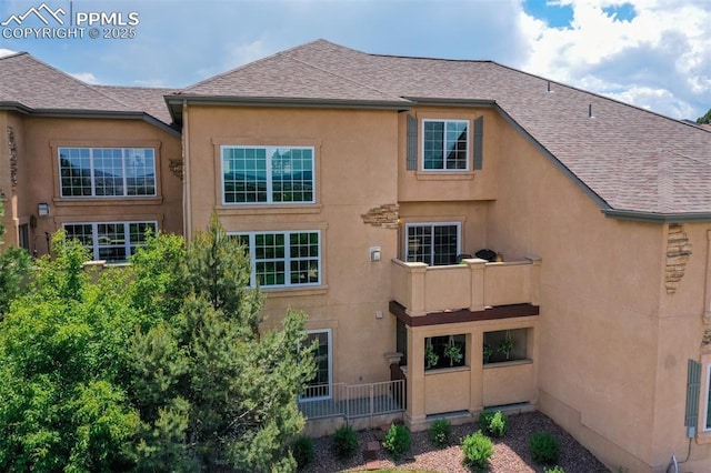 5775 Sonnet Hts, Colorado Springs, CO 80918 - back of house featuring roof with shingles and stucco siding
