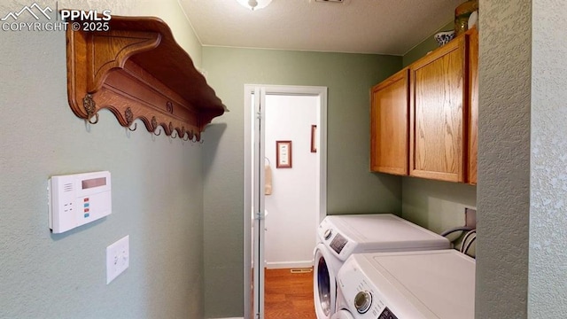 2160 Ance St, Strasburg, CO 80136 - laundry room featuring cabinet space, separate washer and dryer, and wood finished floors