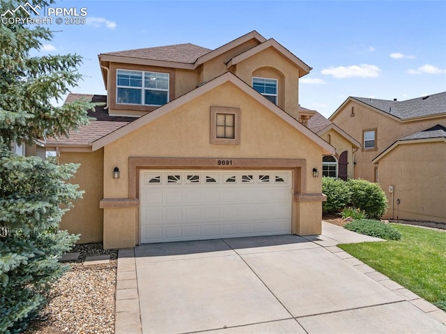 9891 Red Sage Dr, Colorado Springs, CO 80920 - traditional-style house featuring concrete driveway, stucco siding, and a garage