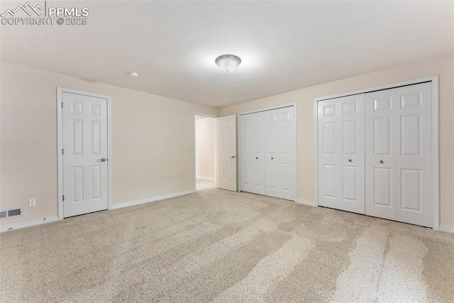 9891 Red Sage Dr, Colorado Springs, CO 80920 - unfurnished bedroom featuring two closets and carpet floors