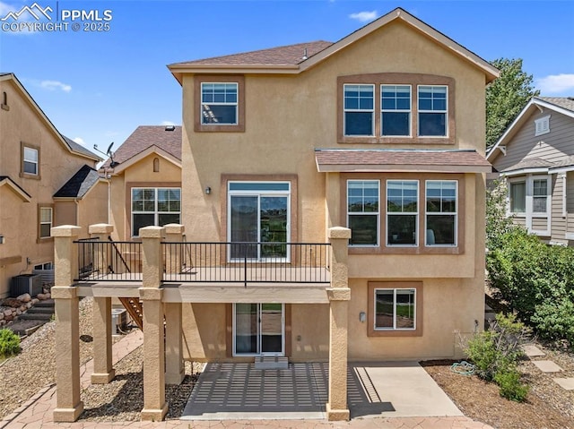 9891 Red Sage Dr, Colorado Springs, CO 80920 - view of front of house with stucco siding, a patio, roof with shingles, and a deck