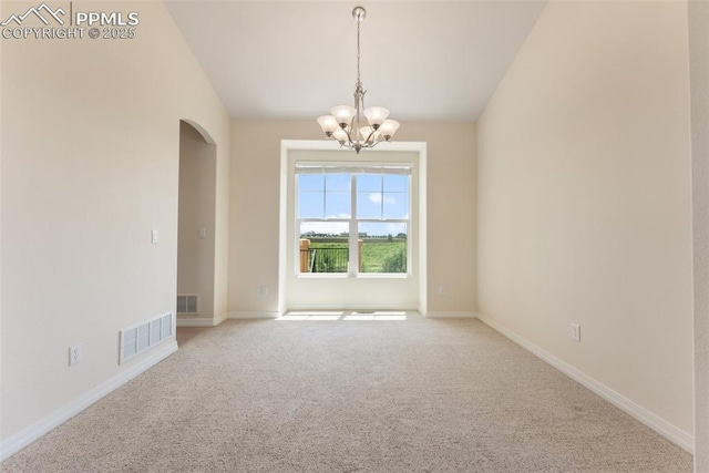 9891 Red Sage Dr, Colorado Springs, CO 80920 - spare room featuring arched walkways, a chandelier, carpet floors, and vaulted ceiling