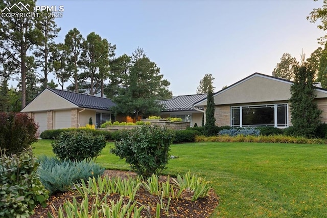 18 2nd St, Colorado Springs, CO 80906 - view of front of home with a standing seam roof, a front lawn, and stone siding