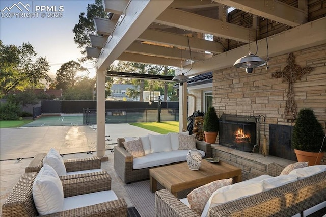 18 2nd St, Colorado Springs, CO 80906 - patio terrace at dusk featuring an outdoor living space with a fireplace and a patio