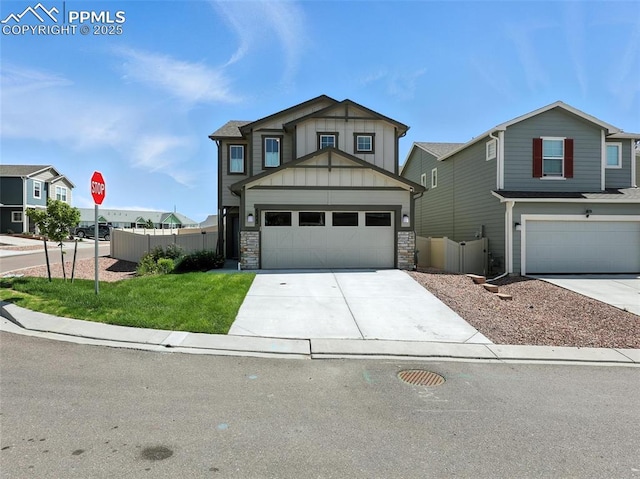 6222 Barr Pt, Colorado Springs, CO 80924 - view of front facade featuring driveway, board and batten siding, a garage, and stone siding