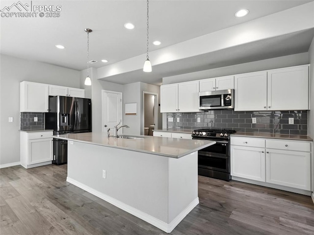 6222 Barr Pt, Colorado Springs, CO 80924 - kitchen featuring gas stove, stainless steel microwave, fridge with ice dispenser, dark wood-style flooring, and recessed lighting