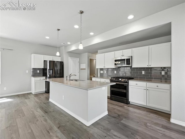 6222 Barr Pt, Colorado Springs, CO 80924 - kitchen featuring stainless steel appliances, backsplash, wood finished floors, recessed lighting, and white cabinets