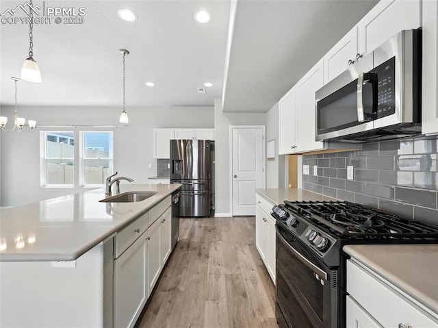6222 Barr Pt, Colorado Springs, CO 80924 - kitchen with stainless steel appliances, light countertops, tasteful backsplash, light wood-type flooring, and recessed lighting