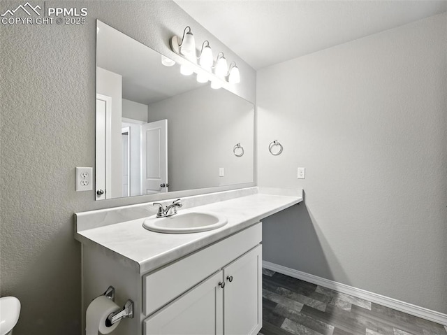 6222 Barr Pt, Colorado Springs, CO 80924 - bathroom featuring vanity, wood finished floors, and a textured wall