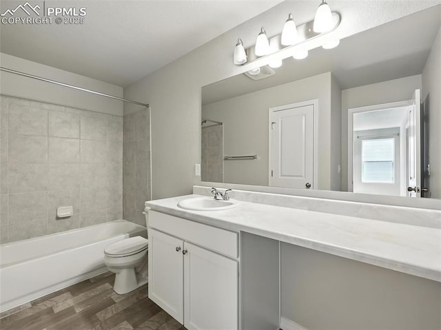 6222 Barr Pt, Colorado Springs, CO 80924 - full bathroom with wood finished floors, vanity, and  shower combination