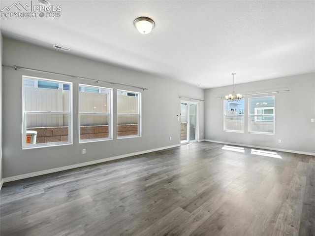 6222 Barr Pt, Colorado Springs, CO 80924 - unfurnished living room with a chandelier and wood finished floors