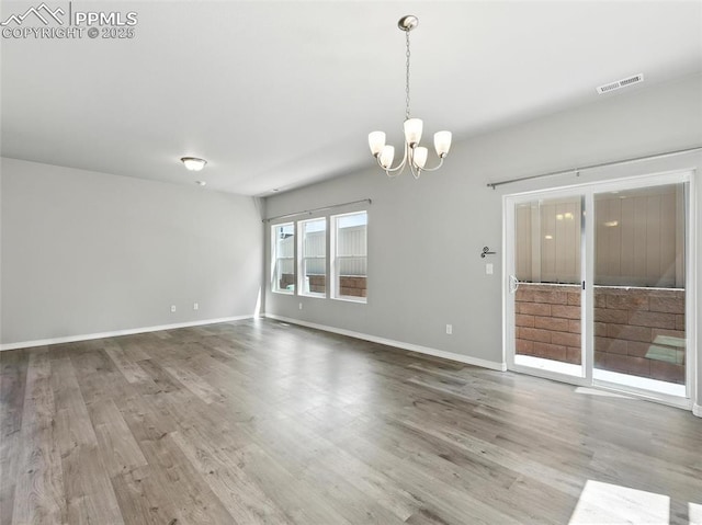 6222 Barr Pt, Colorado Springs, CO 80924 - spare room with a chandelier and wood finished floors