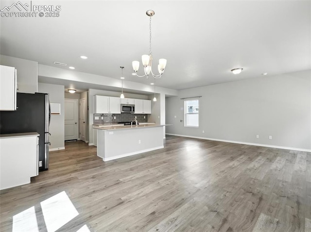 6222 Barr Pt, Colorado Springs, CO 80924 - kitchen featuring appliances with stainless steel finishes, a chandelier, open floor plan, recessed lighting, and light wood finished floors