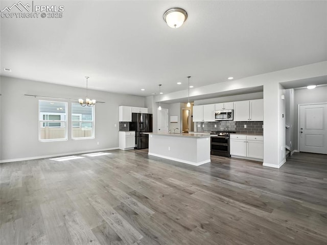 6222 Barr Pt, Colorado Springs, CO 80924 - unfurnished living room with a chandelier, dark wood-type flooring, and recessed lighting