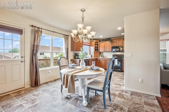 6372 Shooting Iron Way, Colorado Springs, CO 80923 - dining space featuring a chandelier, recessed lighting, and light stone finish floors