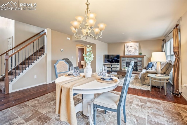 6372 Shooting Iron Way, Colorado Springs, CO 80923 - dining space featuring stairs, a chandelier, wood finished floors, and arched walkways