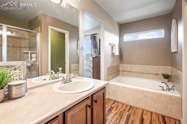 6372 Shooting Iron Way, Colorado Springs, CO 80923 - bathroom with a garden tub, wood finished floors, vanity, and a shower stall