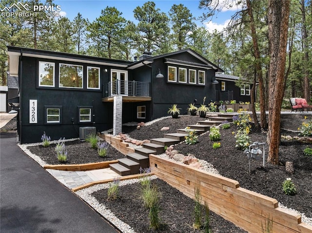 1320 Spring Valley Dr, Colorado Springs, CO 80921 - view of front facade featuring stairway, a balcony, and stucco siding