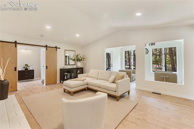 1320 Spring Valley Dr, Colorado Springs, CO 80921 - living area with a barn door, vaulted ceiling, light wood finished floors, and recessed lighting