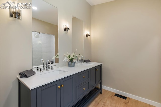 1320 Spring Valley Dr, Colorado Springs, CO 80921 - bathroom featuring double vanity, wood finished floors, and a shower