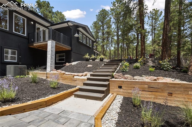 1320 Spring Valley Dr, Colorado Springs, CO 80921 - view of side of home featuring stairway, a balcony, and stucco siding