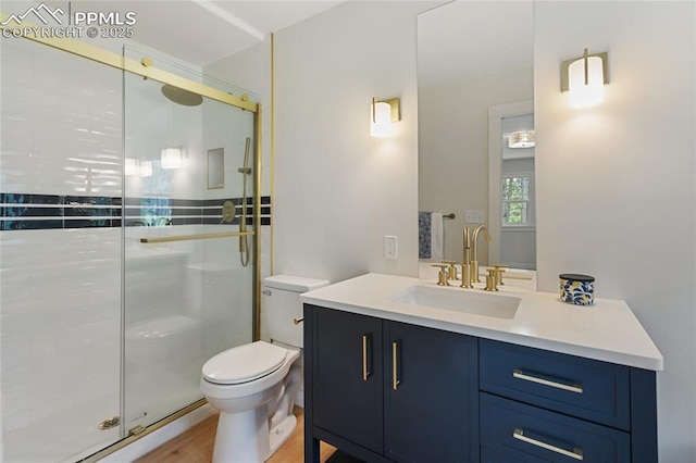 1320 Spring Valley Dr, Colorado Springs, CO 80921 - full bath featuring vanity, a shower stall, and wood finished floors
