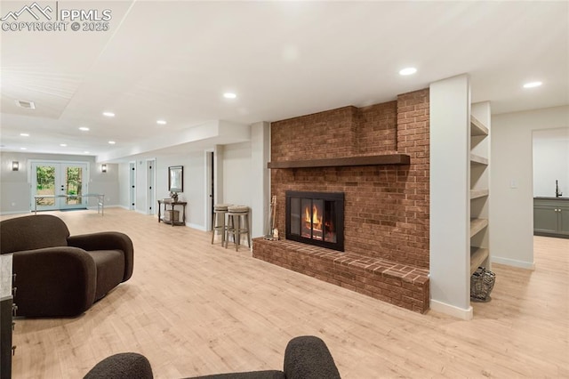 1320 Spring Valley Dr, Colorado Springs, CO 80921 - living room with wood finished floors, a brick fireplace, recessed lighting, and french doors
