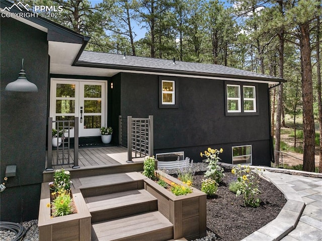 1320 Spring Valley Dr, Colorado Springs, CO 80921 - doorway to property featuring french doors, stucco siding, a shingled roof, and a deck