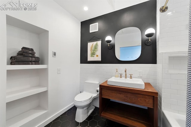 423 W 4th St, Pueblo, CO 81003 - bathroom featuring tile walls, vanity, and tile patterned flooring