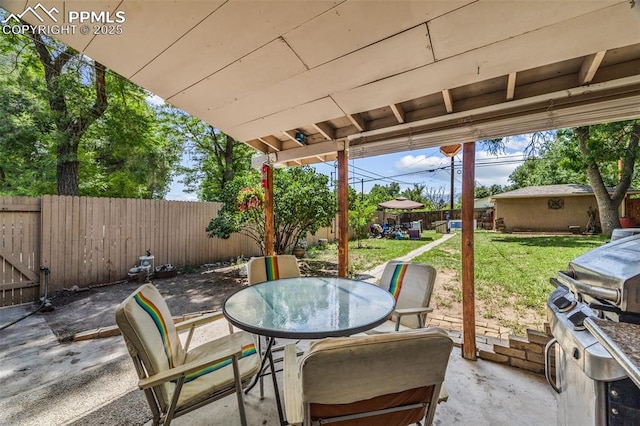 802 Alexander Rd, Colorado Springs, CO 80909 - fenced backyard with a patio and outdoor dining area
