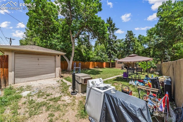 802 Alexander Rd, Colorado Springs, CO 80909 - fenced backyard with a gazebo, an outbuilding, and a detached garage