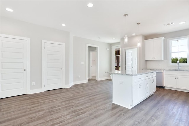 100 Hunters Way, Opelika, AL 36801 - kitchen featuring stainless steel dishwasher, a sink, light wood-type flooring, white cabinets, and recessed lighting