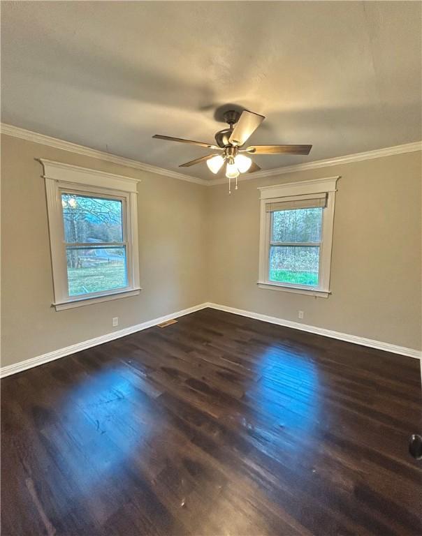 unfurnished bedroom with ceiling fan and dark wood-type flooring