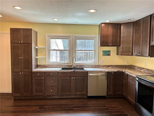 kitchen with dark hardwood / wood-style flooring, stainless steel appliances, and dark brown cabinetry