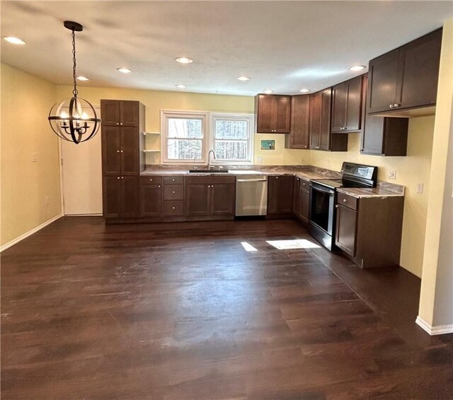 kitchen featuring dark wood-type flooring, hanging light fixtures, stainless steel appliances, and an inviting chandelier