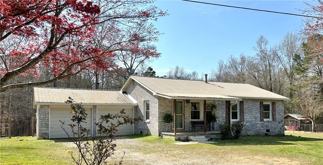 single story home featuring a front yard, central AC, and a garage