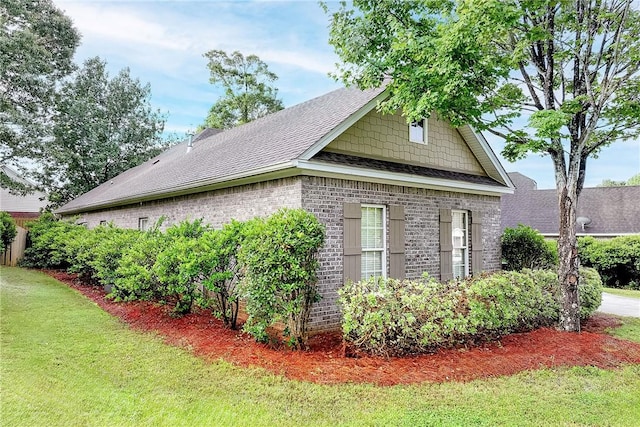 667 Carpenter Way, Auburn, AL 36830 - view of property exterior featuring brick siding, roof with shingles, and a yard