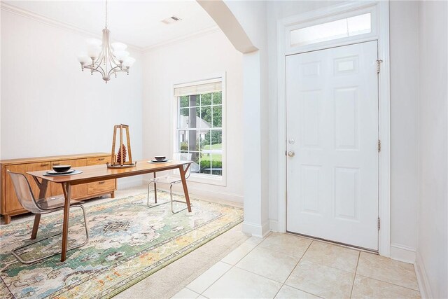 667 Carpenter Way, Auburn, AL 36830 - entryway with crown molding, arched walkways, baseboards, a chandelier, and light tile patterned floors