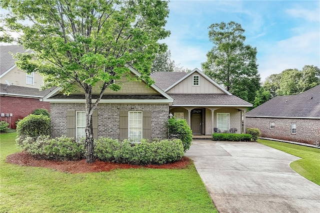 667 Carpenter Way, Auburn, AL 36830 - view of front of home featuring a front lawn, brick siding, driveway, and roof with shingles