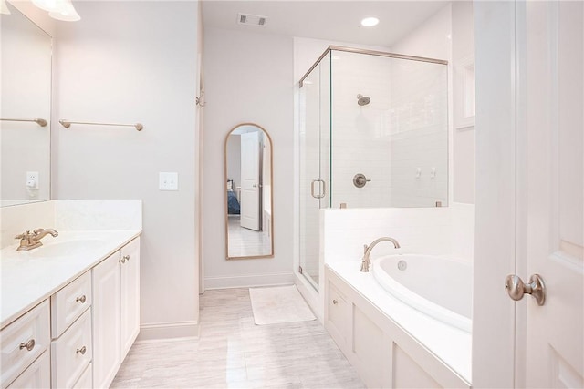 667 Carpenter Way, Auburn, AL 36830 - full bath featuring a garden tub, vanity, a shower stall, baseboards, and recessed lighting