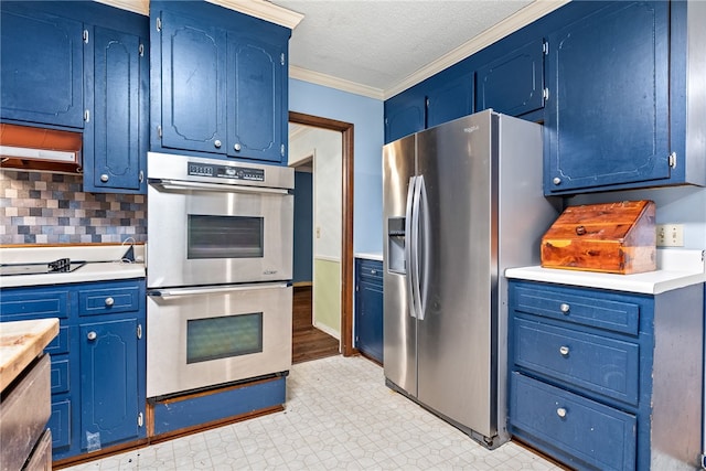 kitchen with blue cabinetry, backsplash, and stainless steel appliances