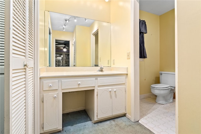 bathroom featuring toilet and vanity