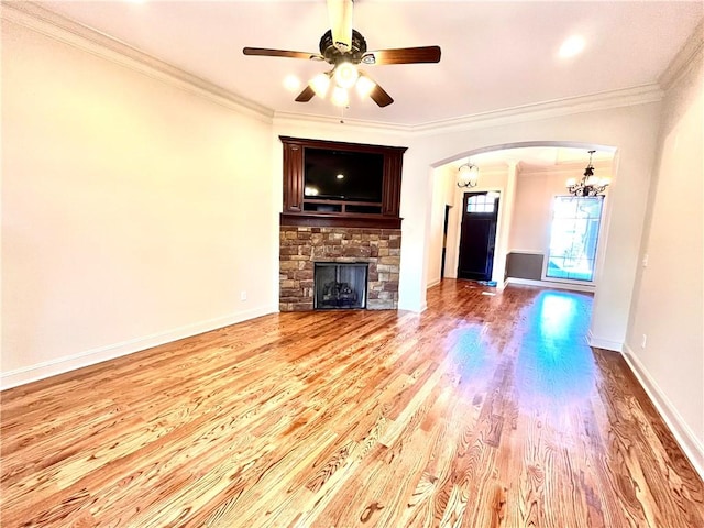 1807 Parsons Cir, Auburn, AL 36830 - unfurnished living room with crown molding, a fireplace, ceiling fan with notable chandelier, and light wood-type flooring