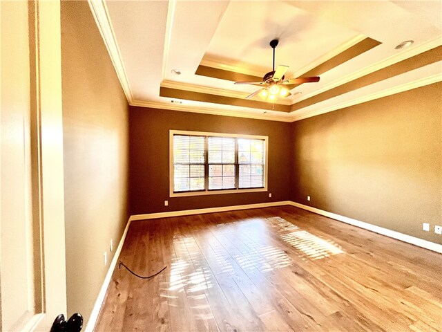 1807 Parsons Cir, Auburn, AL 36830 - empty room featuring a tray ceiling, ceiling fan, hardwood / wood-style floors, and ornamental molding