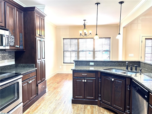 1807 Parsons Cir, Auburn, AL 36830 - kitchen with dark brown cabinetry, sink, hanging light fixtures, appliances with stainless steel finishes, and light wood-type flooring