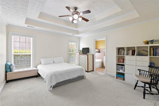 2260 Core Dr, Auburn, AL 36830 - bedroom featuring a raised ceiling, carpet flooring, ornamental molding, connected bathroom, and a ceiling fan