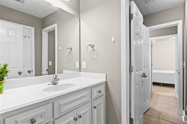 2260 Core Dr, Auburn, AL 36830 - bathroom featuring vanity, tile patterned floors, and a textured ceiling