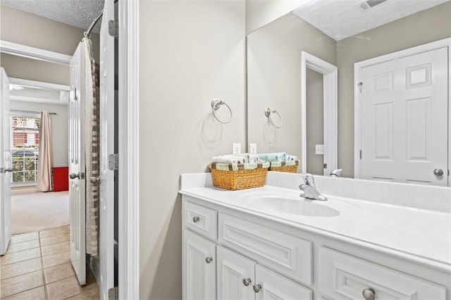 2260 Core Dr, Auburn, AL 36830 - bathroom with vanity, tile patterned floors, and a textured ceiling