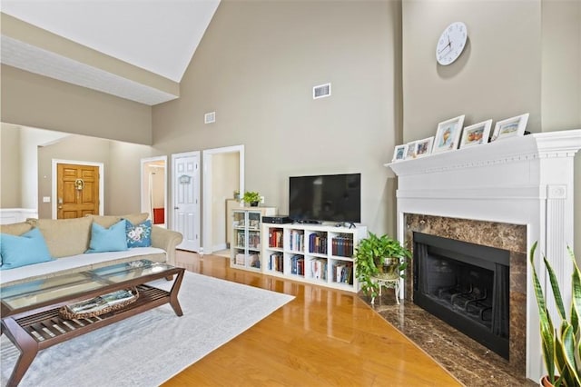 2260 Core Dr, Auburn, AL 36830 - living room with high vaulted ceiling, a fireplace, and wood finished floors