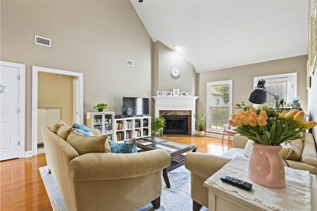 2260 Core Dr, Auburn, AL 36830 - living area with high vaulted ceiling, light wood finished floors, and a fireplace with flush hearth